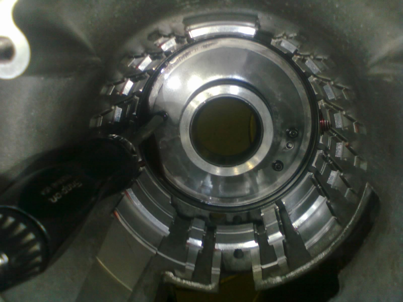 Unbolt the low/reverse clutch piston retainer